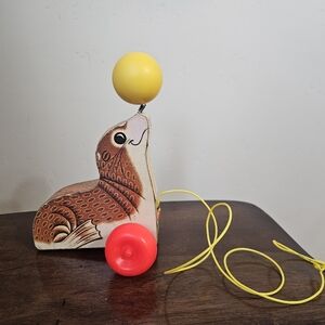 Fisher-Price Wooden Seal Toy with Yellow Ball and Red Wheels 1978